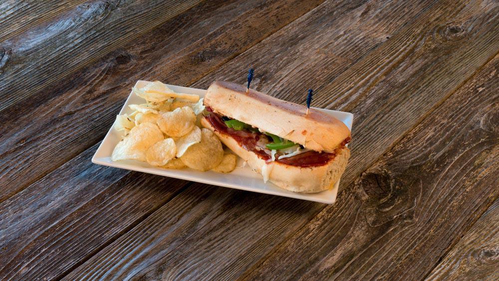 Totally Italian Sub · Pepperoni, salami, canadian-style bacon, green peppers, olives, and onions with our homemade marinara sauce.