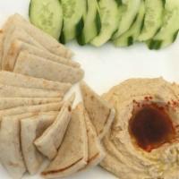 Hummus · Pureed chickpeas blended with sesame seed paste and garlic. Served with warm pita. Make it g...