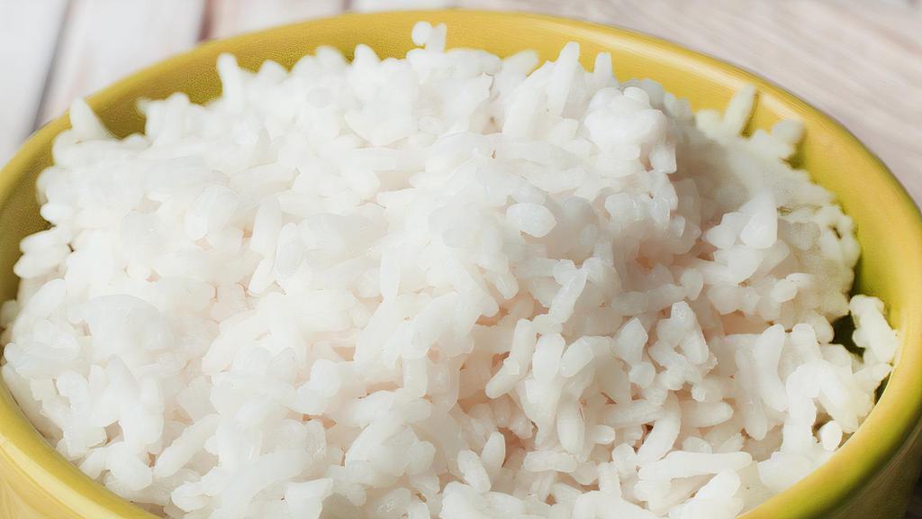 Side Of Coconut Rice · coconut flakes sauteed with coconut milk and infused in white rice