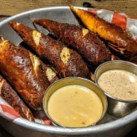 Brew Pretzels · Herb encrusted baked pretzel sticks, boundary cheese sauce, and stout. mustard