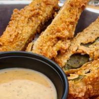 Fried Pickles · Garlic pickle spears, lightly coated with seasoned flour, deep fried. Served with Carolina r...