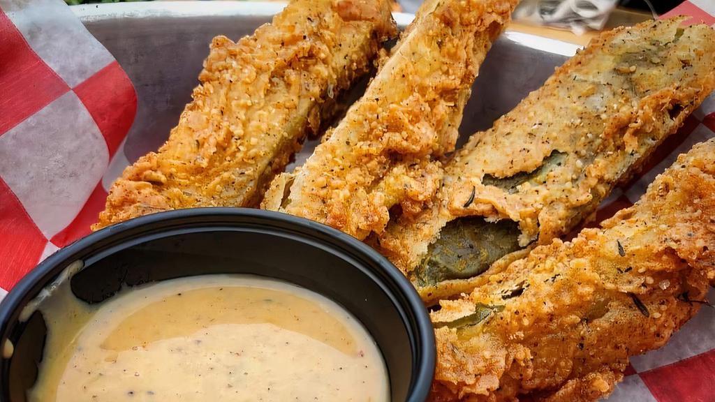 Fried Pickles · Garlic pickle spears, lightly coated with seasoned flour, deep fried. Served with Carolina ranch BBQ