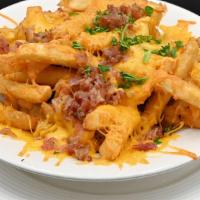 Cheese Fries · A generous portion of our coated fries topped with melted cheese and bacon, served with ranch
