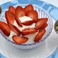 Greek Yogurt · Strained Greek yogurt with fresh strawberries and granola