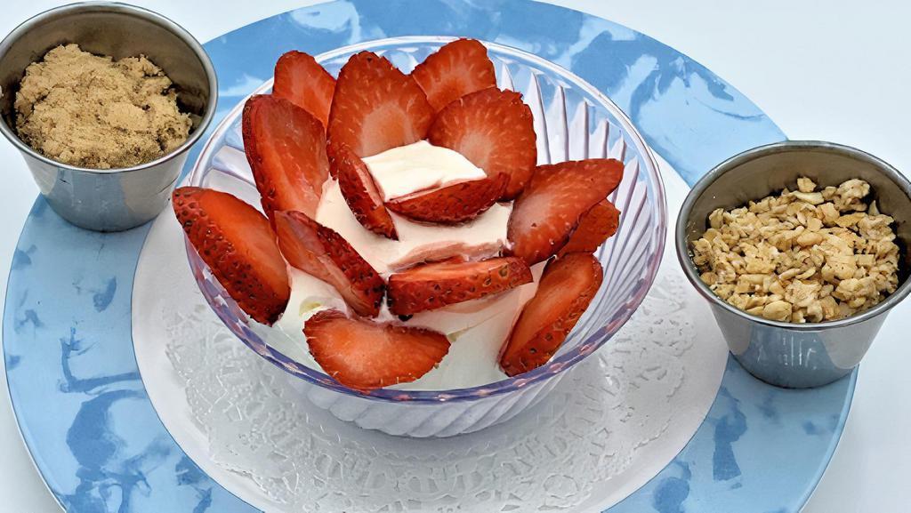 Greek Yogurt · Strained Greek yogurt with fresh strawberries and granola