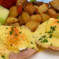 Eggs Benedict · Two poached eggs with capicola ham on toasted English muffins topped with homemade Hollandai...