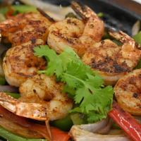 Fajita Shrimp · Our classic fajitas served on a sizzling hot skillet with grilled onions and peppers, sour c...