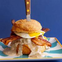 The Rockwell Supreme · Fried chicken, cheddar, goetta sausage gravy, over easy egg and bacon.