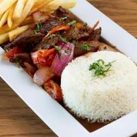 Tallarin Verde Con Lomo Saltado · The most traditional style Peruvian dish! Stir fry of marinated steak with tomato, onions, s...