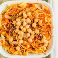 Koshary · Vegan. A hearty dish starring lentils, rice, pasta, and a rich tomato sauce; topped with chi...