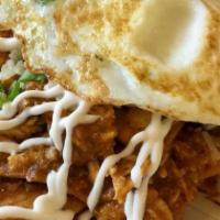 Chilaquiles · Crispy tortilla chips quick-sauteed with house red salsa;  two eggs sunny-side up, sour crea...