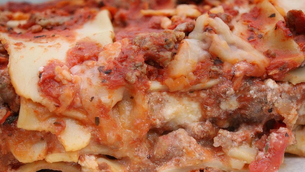 Lasagna, Meat And Cheese · Layered pasta sheets, ground meatballs, bolognese meat sauce, parmesan, ricotta, mozzarella, fresh herbs