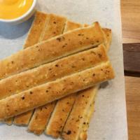 Breadsticks With Cheese · Delicious and warm breadsticks with melted cheese.