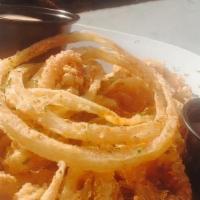 Calamari · hand cut & lightly breaded calamari paired with fried onion slices, served with sweet chili ...