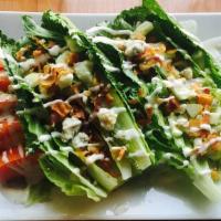 Wedge Salad · with crispy bacon, diced cucumbers, bleu cheese crumbles & tomato wedges