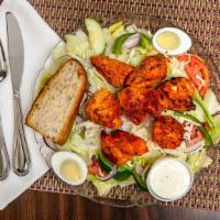 Tandoori Chicken Salad · Mixed greens topped with fresh spicy marinated chicken, mozzarella cheese strips and hard bo...