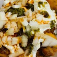 Aloo Tikki Chaat · Potato Fritters Topped With Channa masala, Yogurt,Mint Chutney and Tamarind Sauce. Dusted wi...
