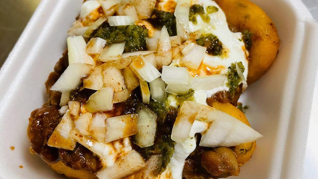 Aloo Tikki Chaat · Potato Fritters Topped With Channa masala, Yogurt,Mint Chutney and Tamarind Sauce. Dusted with Chaat Masala.