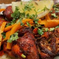Tandoori Chicken · Chicken marinated overnight in a freshly prepared mix of yogurt, spices and herbs, cooked in...