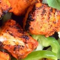 Chicken Tikka · Boneless chunks of chicken marinated in herbs and spices barbecued in a clay oven on a skewer.