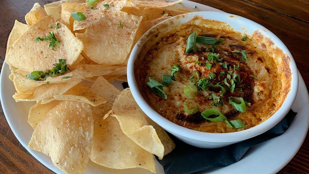 Crab Dip · Baked lump crab meat and poblano cheese gratin, served with chips.