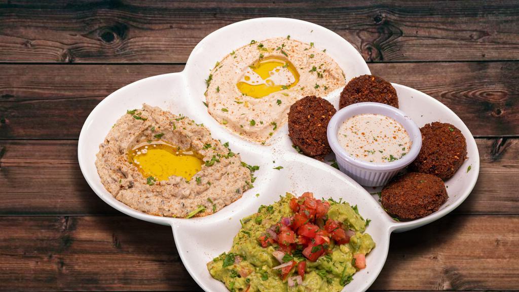 Mixed Dip Plate · Hummus, Falafel & Tahini, Guacamole Babaghanoush. Served with Pita and Tortilla Chips