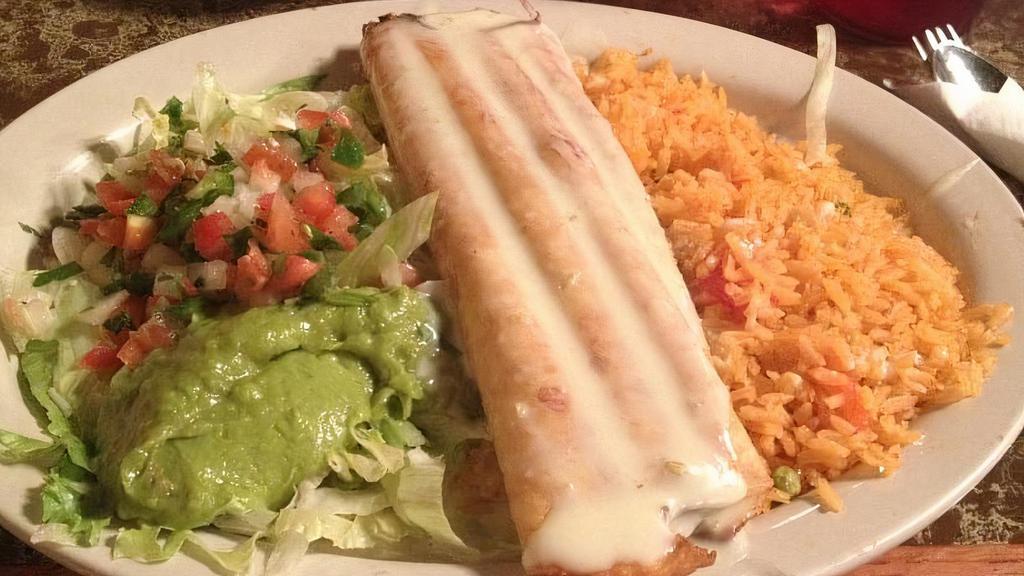 Chimichanga · A flour tortilla stuffed with your choice of filling, beef chunks, or spicy chicken, and deep fried to a  golden brown. Served with lettuce, pico de gallo, sour cream, rice, and beans.