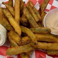 Pickle Fries · Thin, sliced pickle spears breaded and deep fried. Served with our bomb sauce for dipping