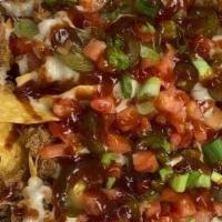 Loaded Nachos · A basket of house-made tortilla chips, smothered with our slow-smoked pulled pork, queso bla...