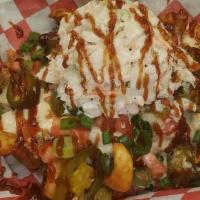 Loaded Fries · A pile of our uniquely seasoned sidewinder potato fries, smothered with our slow-smoked pull...