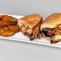 The Cordell · Sliced brisket, creamy mac & cheese topped with, crispy onions, and mild BBQ sauce in a hoag...