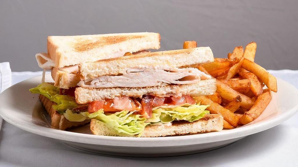 Turkey Club Sandwich Lunch · Mayo, lettuce, tomato, 3 slices of turkey, bacon, and cheese and fries. Consuming raw or undercooked meats, poultry, seafood, shellfish, or egg may increase your risk of foodborne illness, especially if you have certain medical condition.