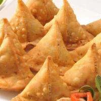 Keema Samosa · Triangular shaped flaky pastry filled with minced chicken and spices (2pcs). Served with min...