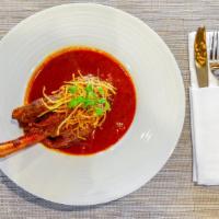 Lamb Shank · Fried Onion tomato-based gravy, slow cooked bone in lamb with homemade whole spices. (Nihari...