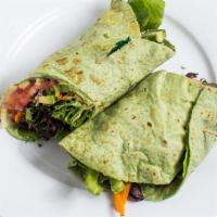 Veggie Wrap · Greens and veggies with avocado in a wrap with hummus spread.