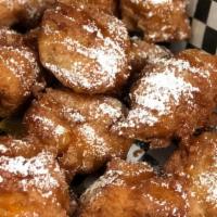 Rhythm Poppers · 8 deep fried chicken and waffle bites topped with syrup and powdered sugar.