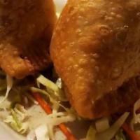 Meat Samosa · Pastries filled with ground lamb, peas, cashews, and spices.