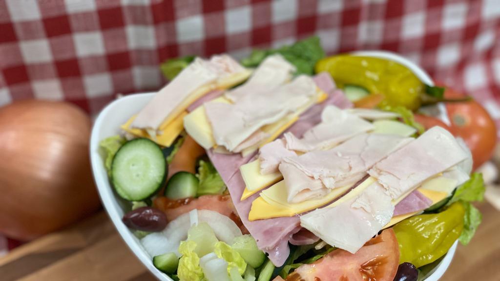 Chef Salad · Sliced turkey breast, ham, provolone & American cheeses on top of crisp lettuce, sliced red ripe tomatoes, onions, cucumbers, olives & pepperoncinis with your choice of dressing