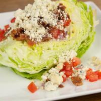 Gorgonzola Wedge Salad · Iceberg lettuce, red onions, Roma tomatoes, and applewood smoked bacon in creamy gorgonzola ...