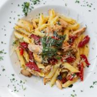 Spicy Chicken Penne · Penne pasta with chicken, sun-dried tomatoes, artichoke hearts, sweet basil, and roasted gar...