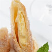 Xango Cheesecake · Filo wrapped cheesecake, fried, and rolled in cinnamon sugar with amaretto and whipped cream.
