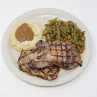 Pork Chops (2 Pc) · Two 5 Oz chops grilled, blackened or fried, mashed potatoes, brown gravy and green beans.