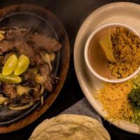 Fajitas 1/2 Lb · 1/2 pound fajita of your choice of steak or chicken, served with flour tortillas, refried be...