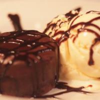Chocolate Volcano · Chocolate brownie volcano with scoop of vanilla ice cream, and drizzled with chocolate sauce.
