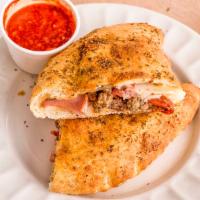 The Calzone · Handmade to order with mozzarella, ricotta & our signature red sauce.