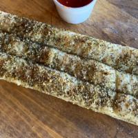 Breadsticks · Three breadsticks served with a side of our famous red sauce.