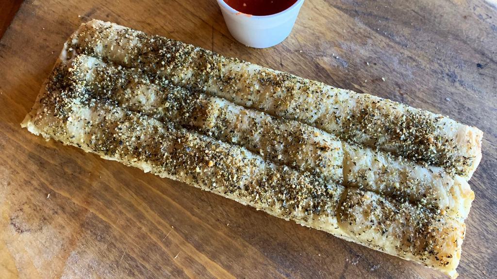Breadsticks · Three breadsticks served with a side of our famous red sauce.
