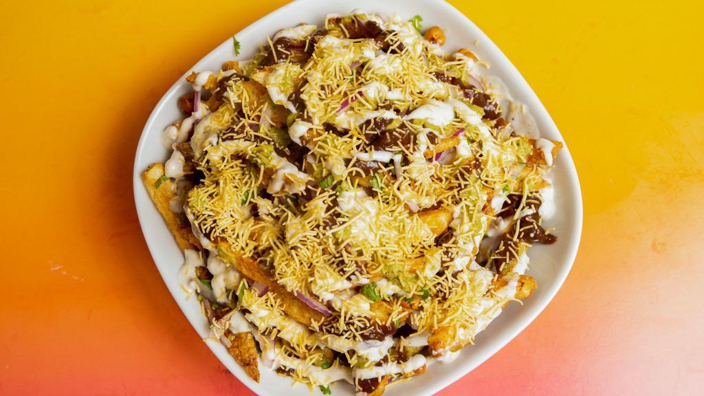 French Fries Chaat · Spiced fries topped with chutneys, tart yogurt and crispy chickpeas.
