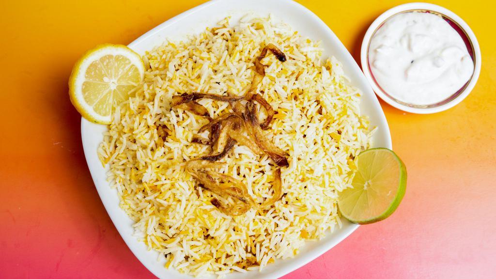 Chicken Biryani · Slow-cooked delicacy layered with aromatic long grain basmati rice and chicken. Served with raita.