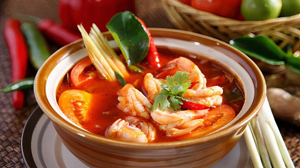 Tom Yum · The most popular hot and sour soup with mushroom, lemongrass, tomato, lime leaves, cilantro with shrimps